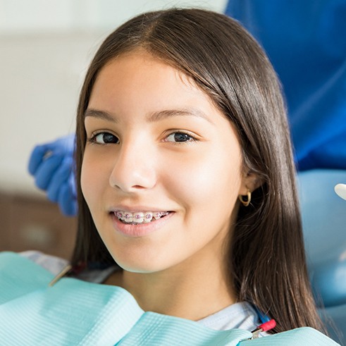 Girl in dental chair with braces about to have exam